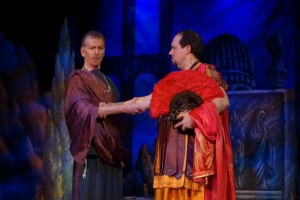 The plotting pagan priest Callistene (Duncan Hartman) greets the Roman general Severo (Robert Garner).